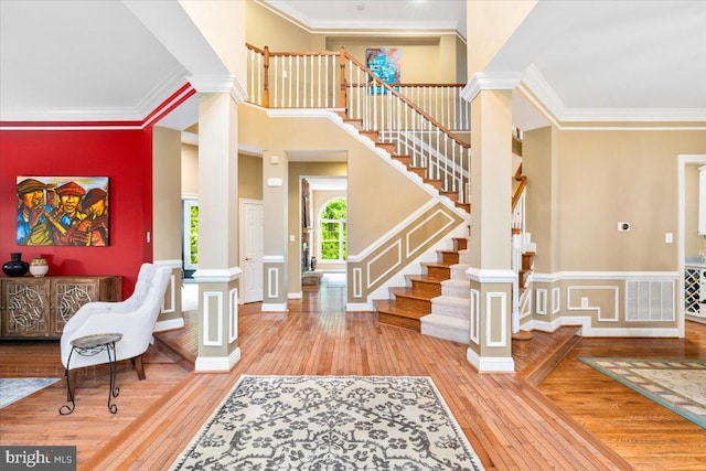 3747 Spicebush Dr, Frederick, MD 21704 - foyer featuring wood-type flooring, stairs, crown molding, and ornate columns