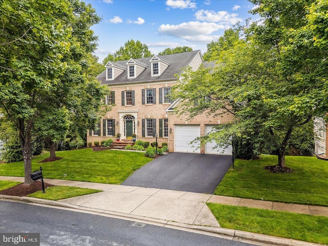 3747 Spicebush Dr, Frederick, MD 21704 - colonial house with asphalt driveway, brick siding, and a front yard
