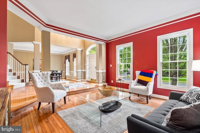 3747 Spicebush Dr, Frederick, MD 21704 - living room featuring decorative columns, ornamental molding, hardwood / wood-style floors, stairway, and baseboards