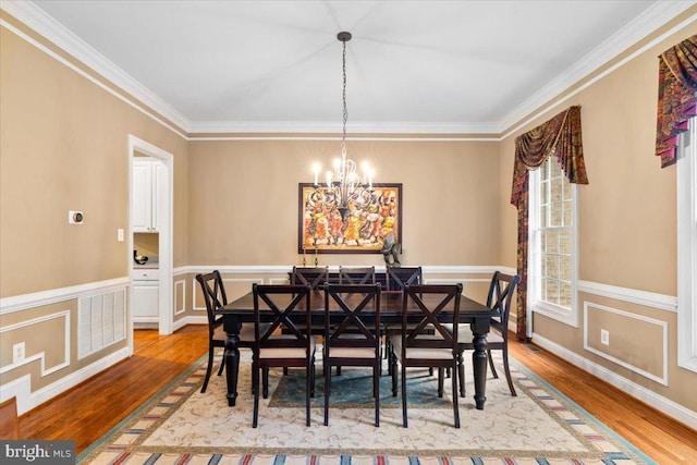 3747 Spicebush Dr, Frederick, MD 21704 - dining area with a chandelier, ornamental molding, and light wood-style flooring