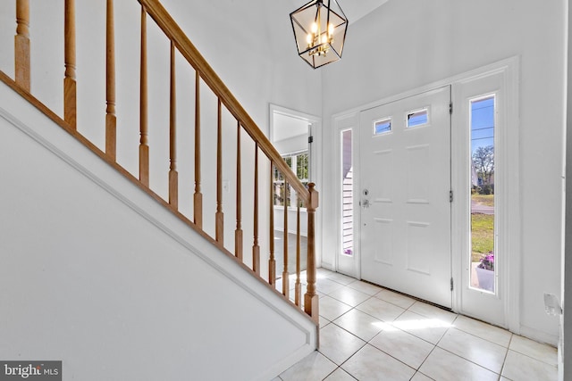316 Nautilus Dr, Manahawkin, NJ 08050 - tiled foyer entrance featuring healthy amount of natural light, stairs, a chandelier, and a high ceiling