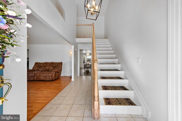 316 Nautilus Dr, Manahawkin, NJ 08050 - entryway featuring stairs, a towering ceiling, tile patterned flooring, and a chandelier