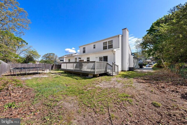 316 Nautilus Dr, Manahawkin, NJ 08050 - back of house with a trampoline, a chimney, a wooden deck, and central AC unit