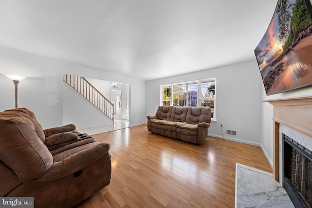 316 Nautilus Dr, Manahawkin, NJ 08050 - living room featuring a premium fireplace, wood finished floors, stairway, and baseboards