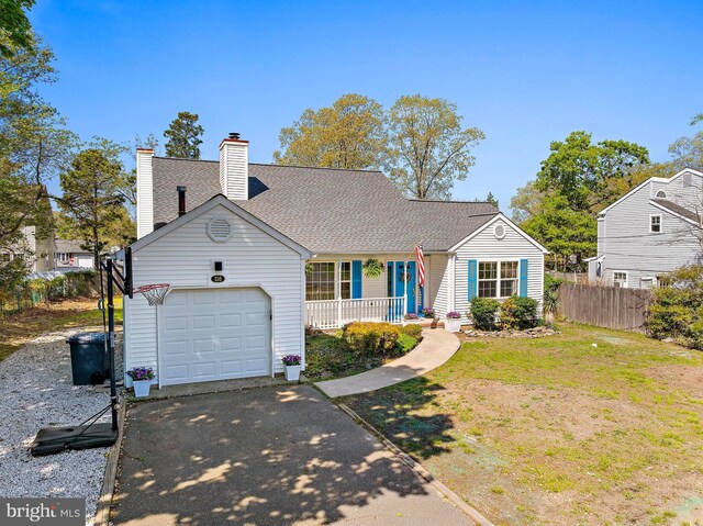 316 Nautilus Dr, Manahawkin, NJ 08050 - view of front of property featuring an attached garage, asphalt driveway, covered porch, and a chimney