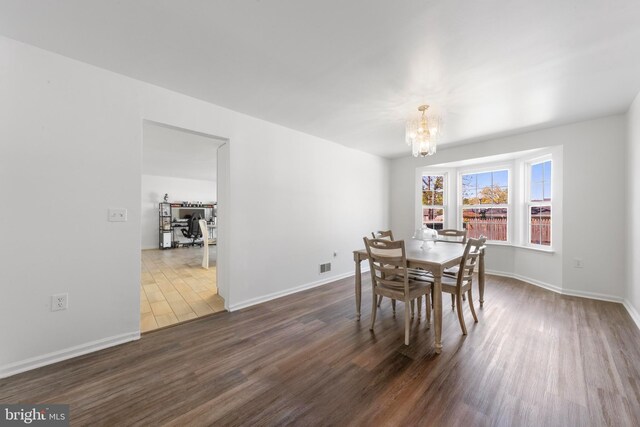 316 Nautilus Dr, Manahawkin, NJ 08050 - dining area featuring dark wood-style flooring, a chandelier, and baseboards