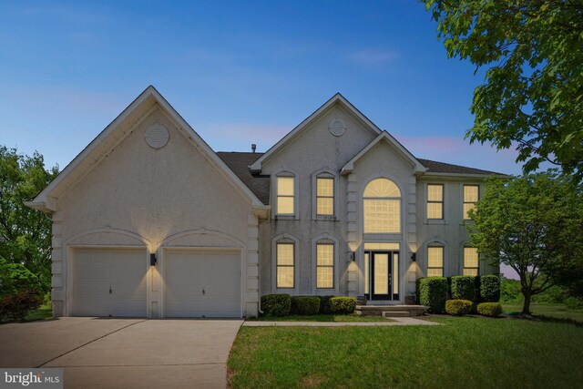 22 Sawgrass Dr, Mount Holly, NJ 08060 - view of front of property featuring driveway, a garage, and a front lawn
