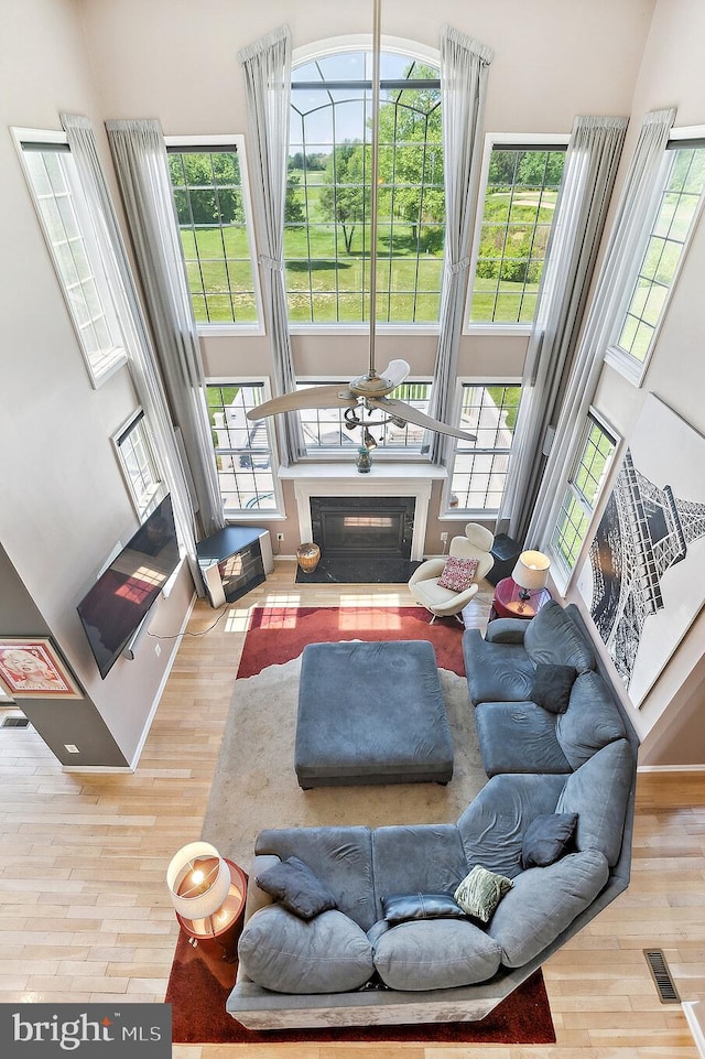 22 Sawgrass Dr, Mount Holly, NJ 08060 - living area with a towering ceiling, wood finished floors, plenty of natural light, and a fireplace with flush hearth