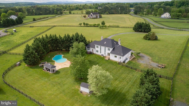 aerial view of sparsely populated area featuring agricultural land and a pool area