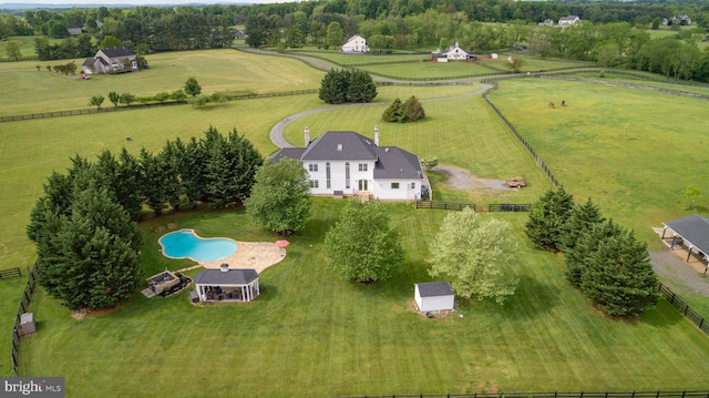 view of rural area featuring a pool area and agricultural land