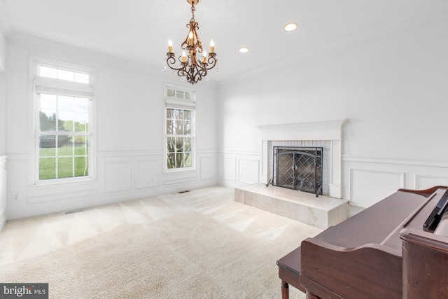living room with healthy amount of natural light, a chandelier, recessed lighting, a decorative wall, and a high end fireplace