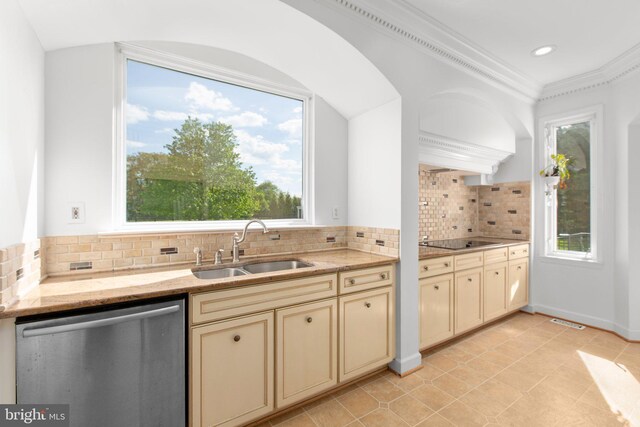 kitchen featuring dishwasher, a sink, cream cabinets, black electric stovetop, and healthy amount of natural light
