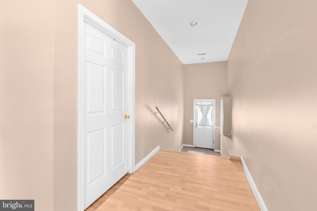 entryway with light wood finished floors and baseboards