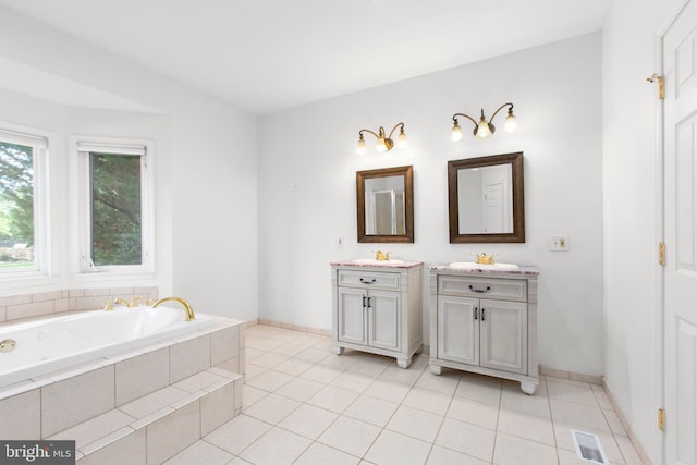 full bathroom featuring vanity, a bath, and tile patterned floors
