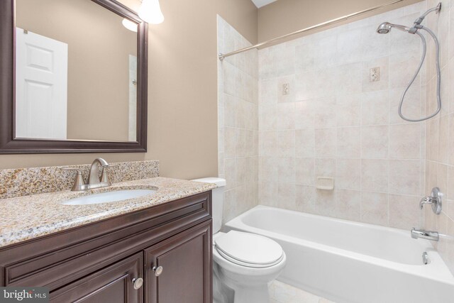 bathroom with toilet, shower / bath combination, and vanity