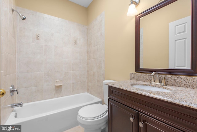 bathroom with toilet, vanity, and shower / bath combination