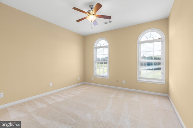 spare room featuring baseboards, carpet flooring, and a ceiling fan