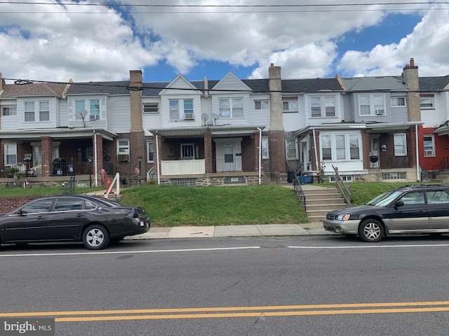 townhome / multi-family property with a residential view and brick siding