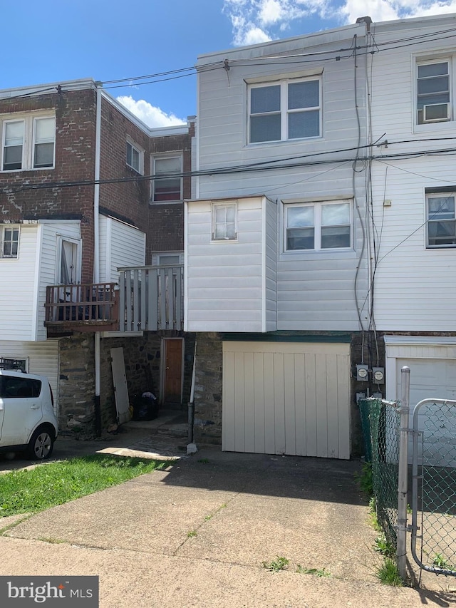 back of house featuring fence