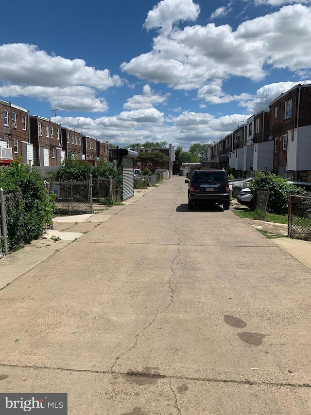 view of street featuring a residential view and a gate