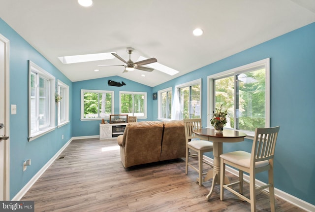 sunroom with a skylight and lofted ceiling