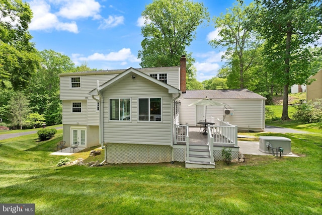 rear view of property with a deck, french doors, a lawn, and a chimney