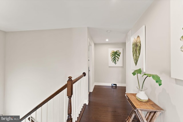 hall with dark wood-style floors, baseboards, and recessed lighting