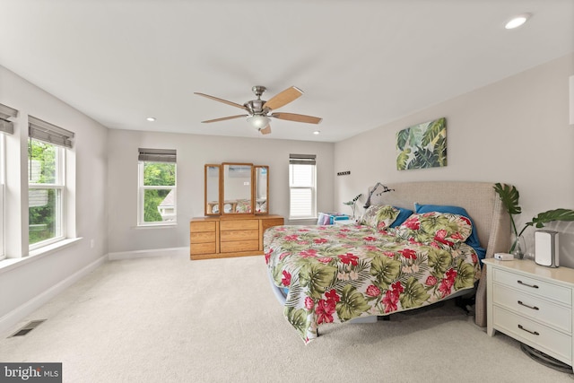 bedroom with light carpet, multiple windows, baseboards, ceiling fan, and recessed lighting