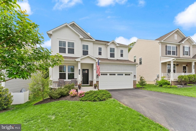 view of front facade with a porch, asphalt driveway, a front yard, and an attached garage