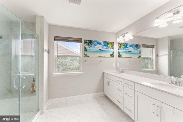 bathroom featuring a marble finish shower, baseboards, marble finish flooring, and double vanity