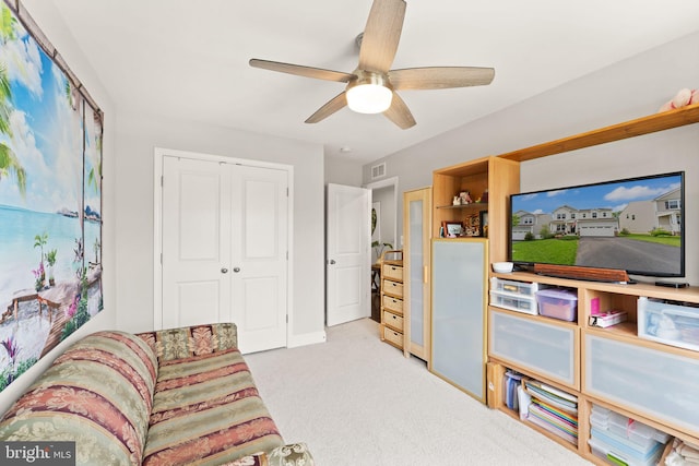 sitting room featuring ceiling fan, light carpet, and baseboards