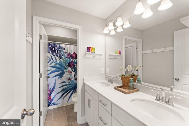bathroom with toilet, tile patterned floors, double vanity, baseboards, and a shower with curtain