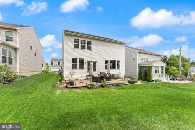 rear view of property with outdoor lounge area, a lawn, and a patio area