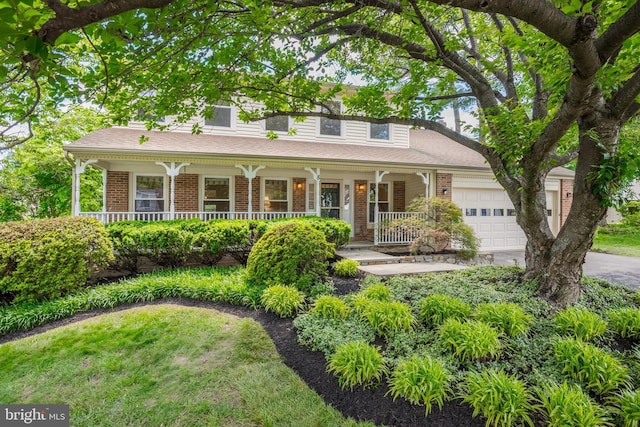 8 Botany Ct, North Potomac, MD 20878 - view of front of house featuring a porch, a garage, brick siding, and driveway