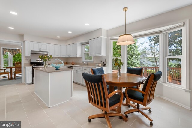 8 Botany Ct, North Potomac, MD 20878 - kitchen with stainless steel gas stove, under cabinet range hood, light countertops, a sink, and white cabinets