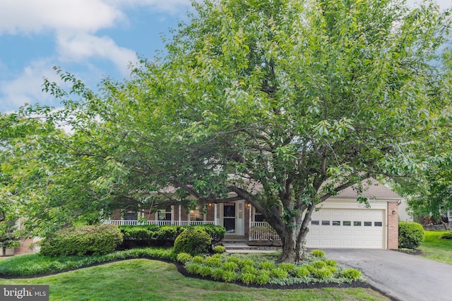 8 Botany Ct, North Potomac, MD 20878 - obstructed view of property featuring brick siding, driveway, an attached garage, and a front lawn