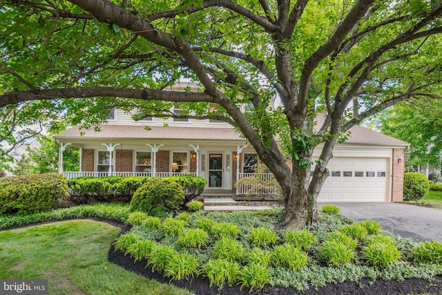 8 Botany Ct, North Potomac, MD 20878 - view of front of property with brick siding, driveway, a porch, and an attached garage