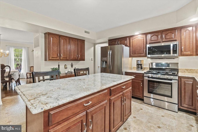 2218 W Greenleaf Dr W, Frederick, MD 21702 - kitchen featuring stainless steel appliances, a chandelier, light stone counters, a center island, and light tile patterned floors