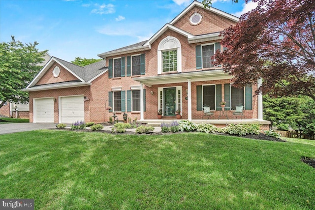 2218 W Greenleaf Dr W, Frederick, MD 21702 - view of front of home with brick siding, covered porch, an attached garage, and driveway