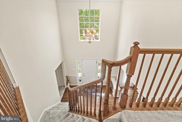 2218 W Greenleaf Dr W, Frederick, MD 21702 - stairway with a chandelier, baseboards, carpet, and a towering ceiling