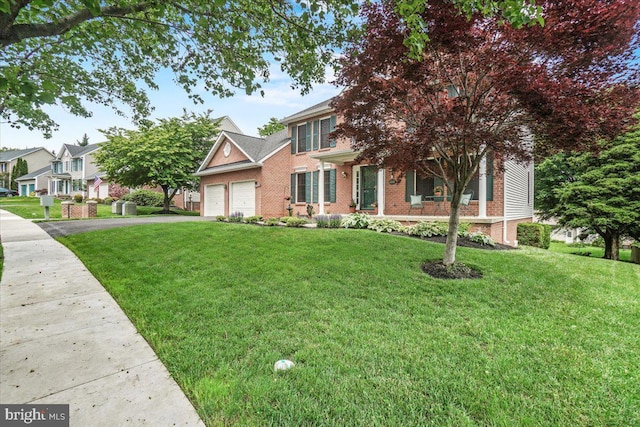 2218 W Greenleaf Dr W, Frederick, MD 21702 - view of front of home with brick siding, an attached garage, asphalt driveway, and a front yard