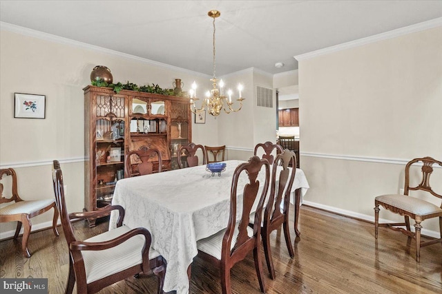 2218 W Greenleaf Dr W, Frederick, MD 21702 - dining room featuring wood finished floors, a chandelier, crown molding, and baseboards