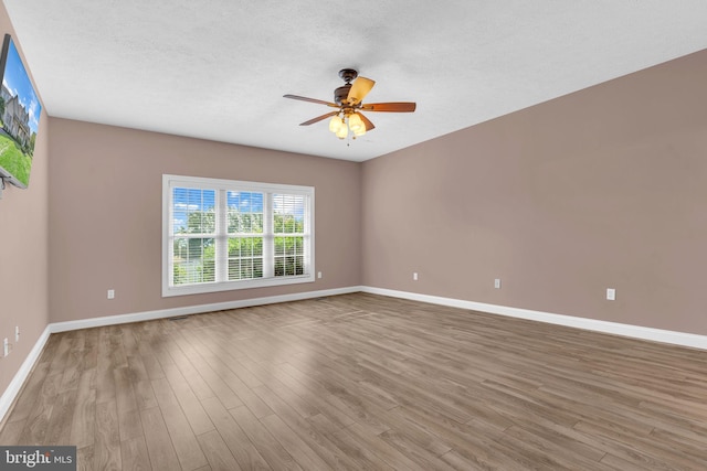 9420 River View Rd, Broomes Island, MD 20615 - spare room with baseboards, wood finished floors, a ceiling fan, and a textured ceiling