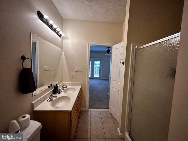 331 Lora Dr, Woodstock, VA 22664 - full bath with tile patterned flooring, a shower stall, a textured ceiling, ceiling fan, and double vanity