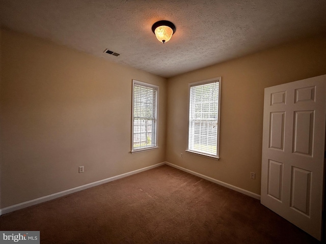331 Lora Dr, Woodstock, VA 22664 - unfurnished room featuring baseboards, healthy amount of natural light, a textured ceiling, and dark colored carpet