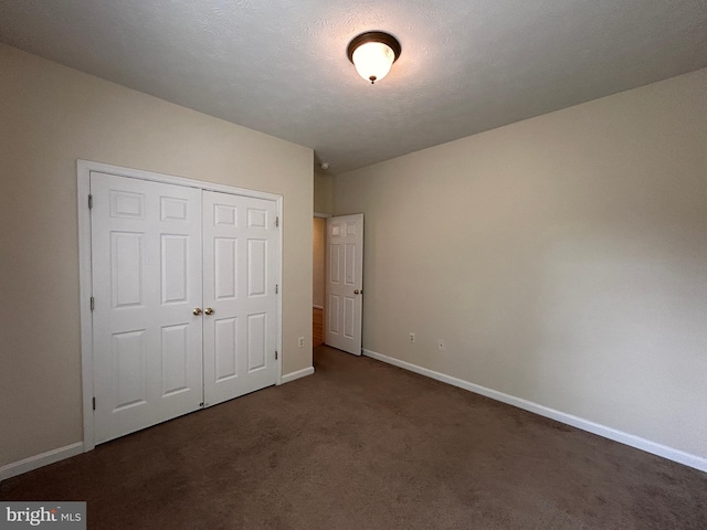 331 Lora Dr, Woodstock, VA 22664 - unfurnished bedroom with dark carpet, baseboards, and a closet