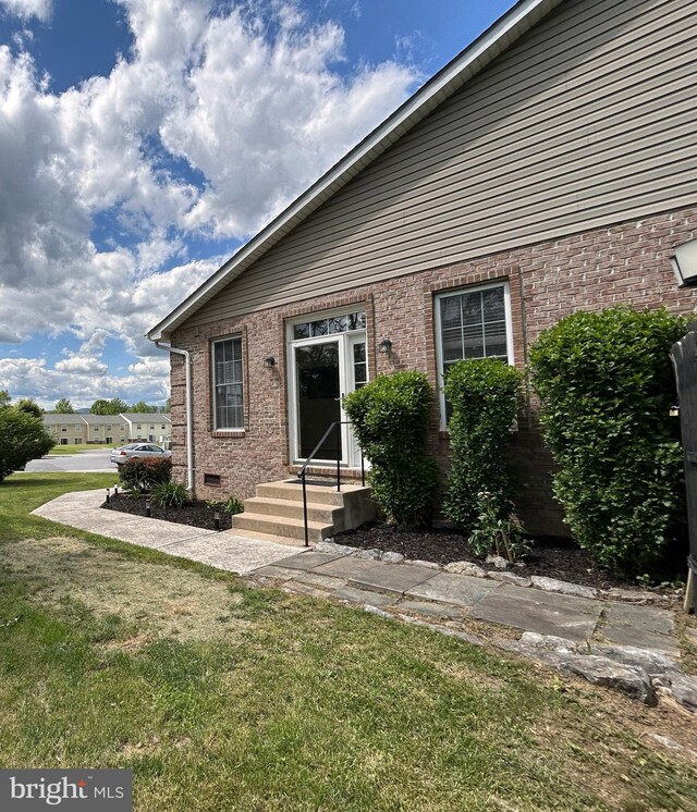 331 Lora Dr, Woodstock, VA 22664 - back of property with a lawn and brick siding