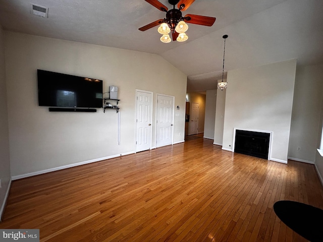331 Lora Dr, Woodstock, VA 22664 - unfurnished living room with a ceiling fan, hardwood / wood-style floors, a fireplace, vaulted ceiling, and baseboards