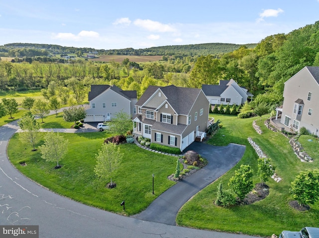 view of subject property with a heavily wooded area