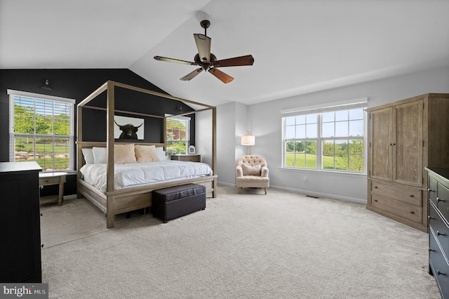 carpeted bedroom with multiple windows, lofted ceiling, ceiling fan, and baseboards